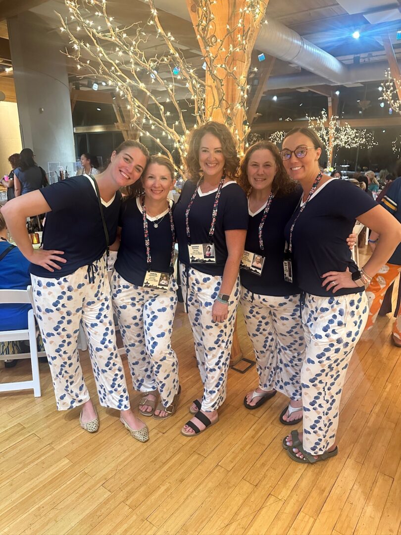 Mothers of children with Down syndrome pose together at a Down syndrome retreat event.
