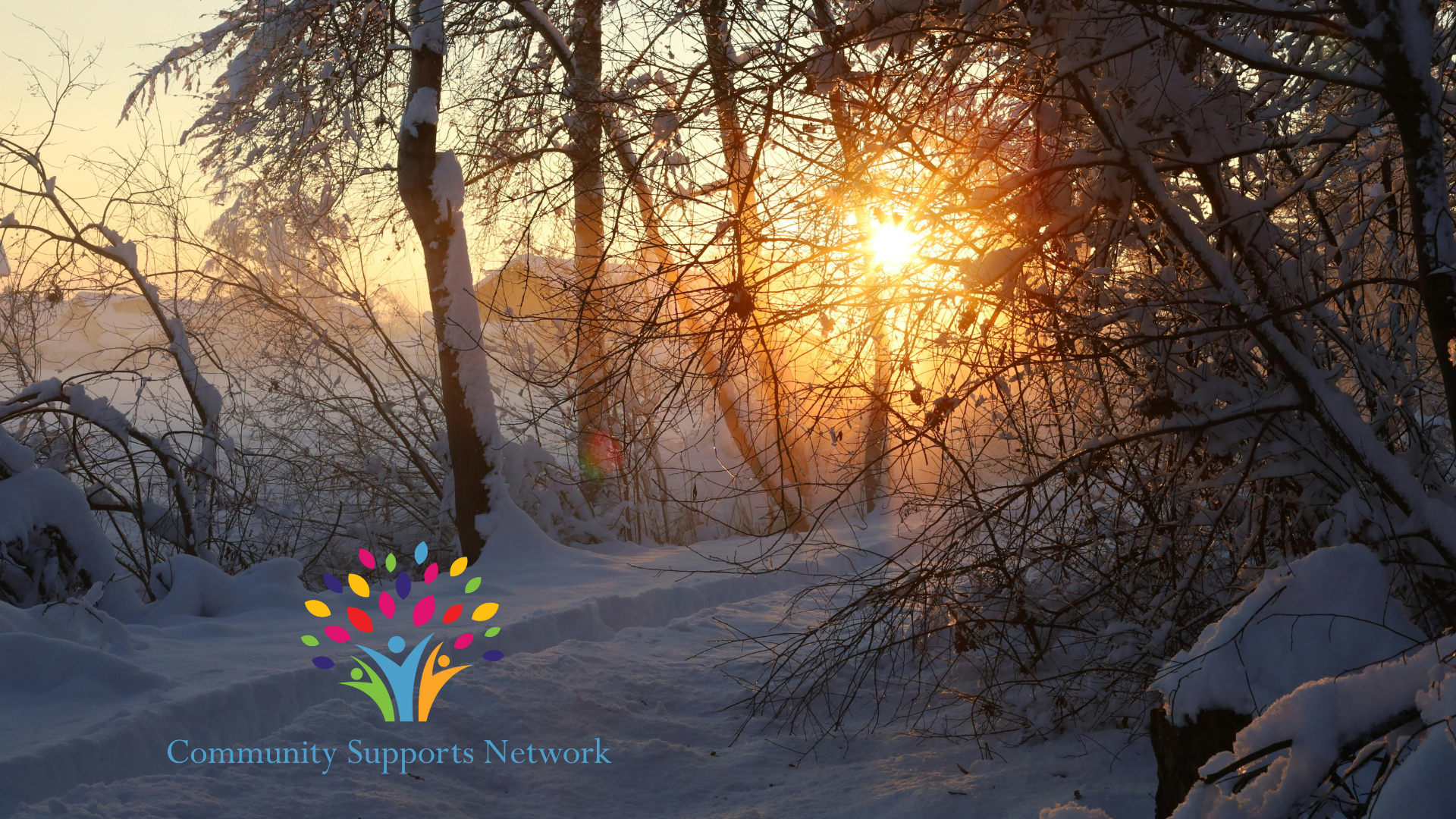 Photo of a wintry snow-covered landscape, with our company logo and name at the bottom left corner of the image.  The scene in this image is illustrative of the topic of this post regarding the cold winter season when we work hard to ensure wellness of all the individuals with disabilities that we support.