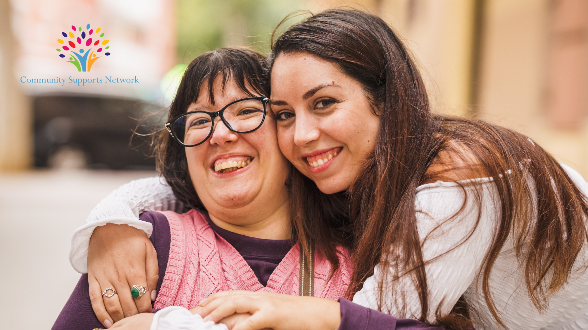 Photo of a direct support professional (DSP) embracing a client with special needs, embodying the spirit of making connections.  This picture exemplifies the topic of this Tip Tuesday post about five ways to build social connections in your community.