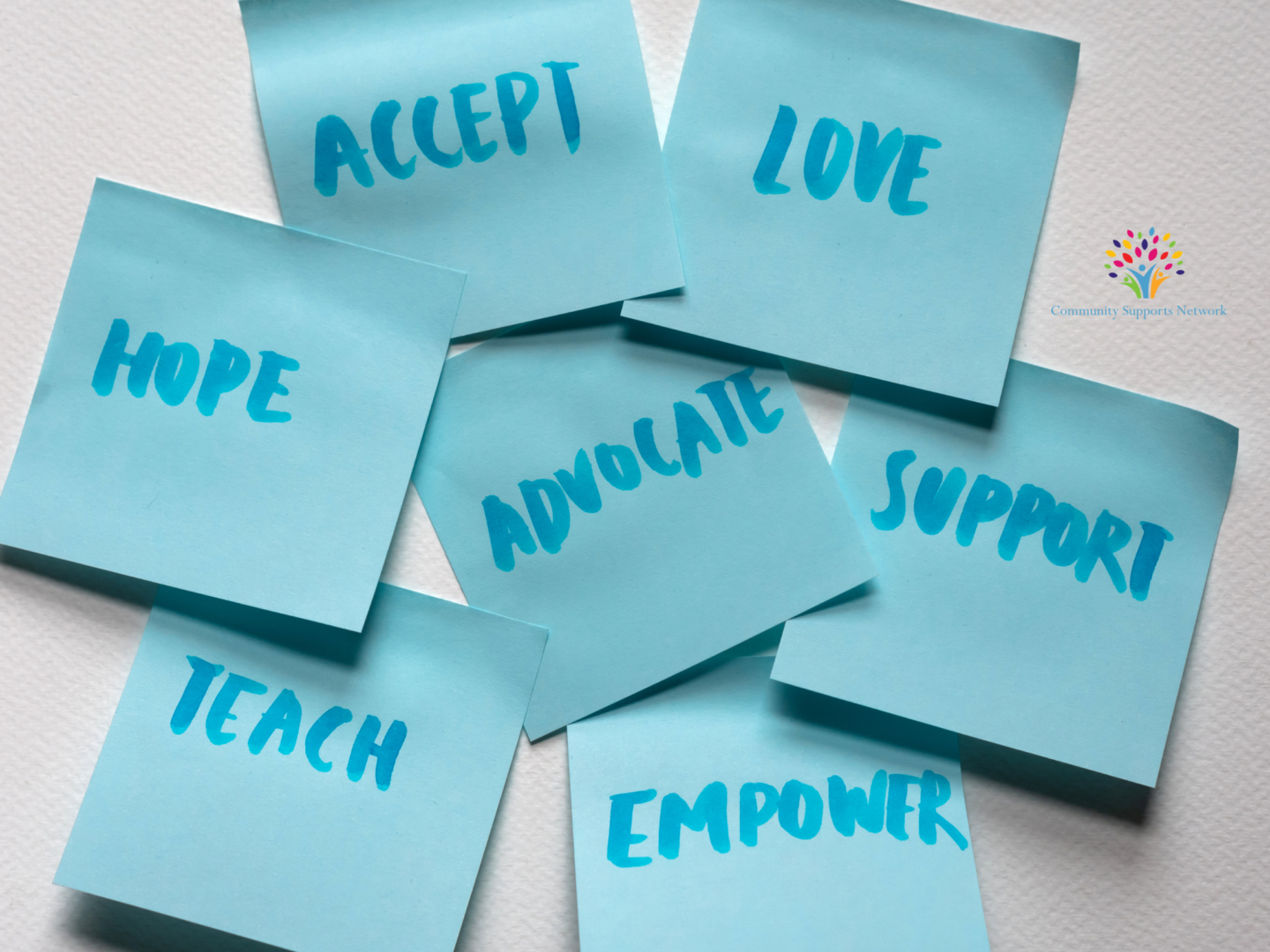 Image of blue post-it notes with words like hope, love, accept, advocate, empower, teach, support, all of which are part of the topic for today's blog post about how families can advocate for their loved ones with disabilities.