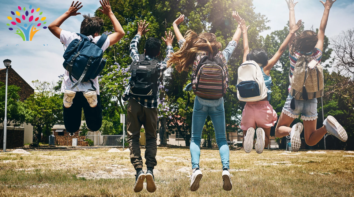 Photo of five students jumping up for joy at the start of summer, which is part of the topic of this blog post about helping individuals with disabilities making the transition with support and focus on boosting independence and making social connections.